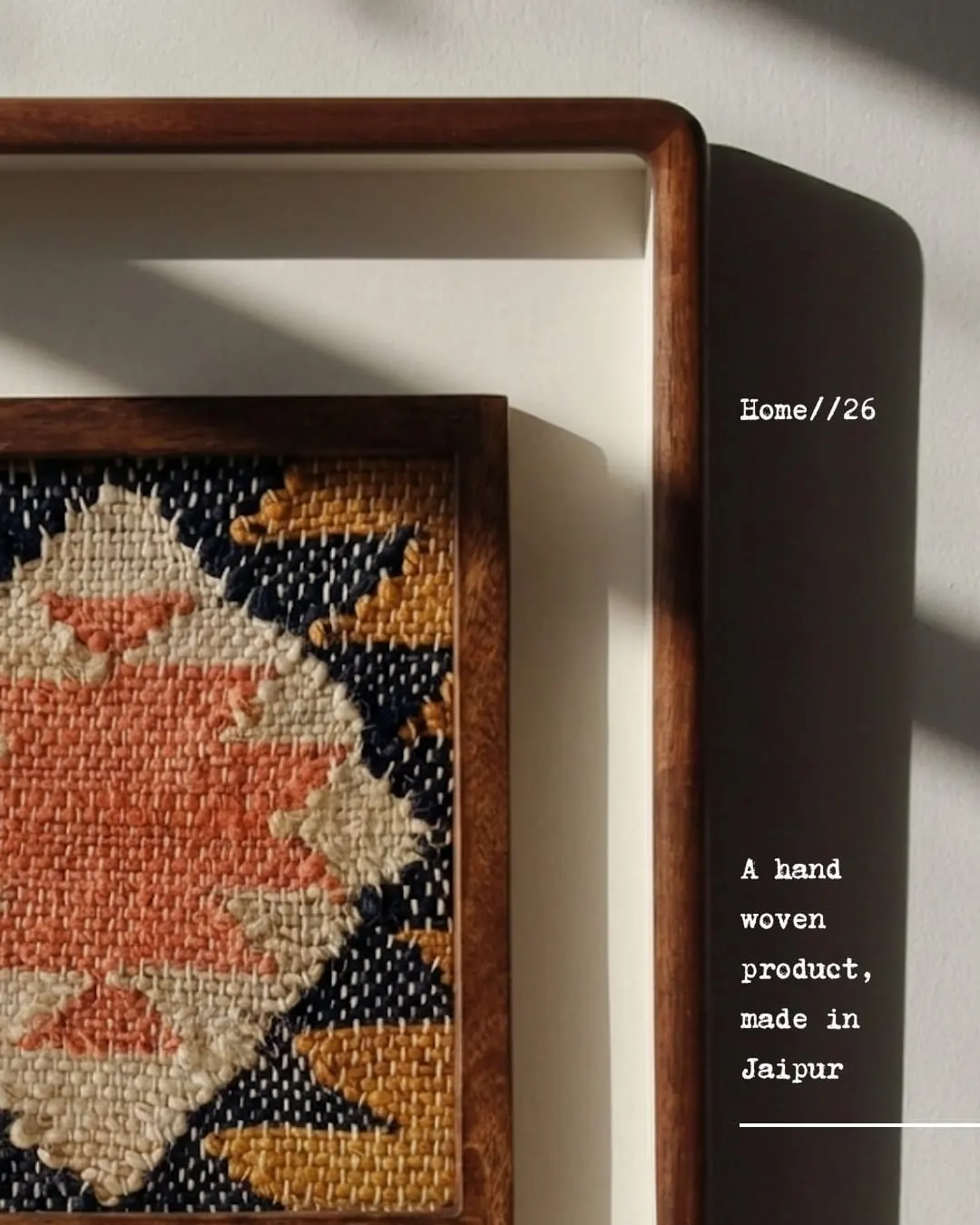 Close-up of a framed hand-woven piece. Text reads A hand woven product, made in Jaipur.