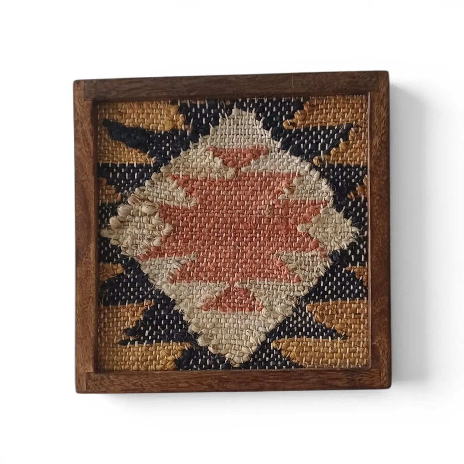 A small framed kilim-style weave with a coral diamond on navy and mustard, in a wooden frame
