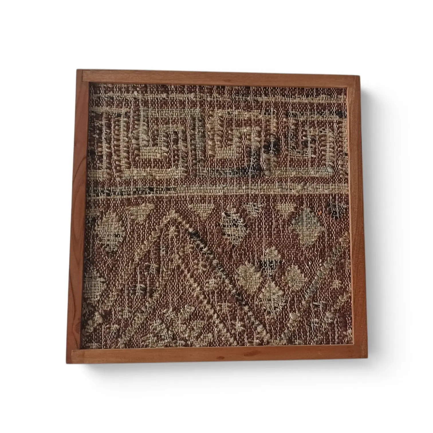 A framed hand-woven piece in rust and natural tones with a geometric border, in a wooden frame