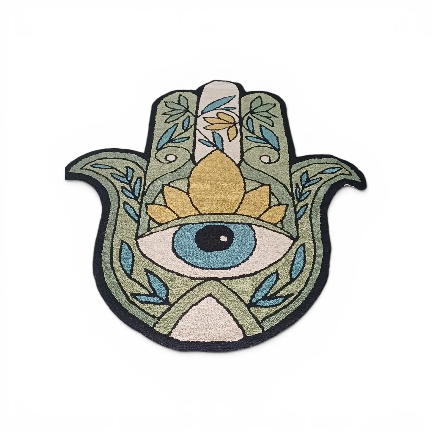 A hamsa-hand shaped rug in sage green with a blue evil eye, a gold lotus and leaf motifs, on a white background