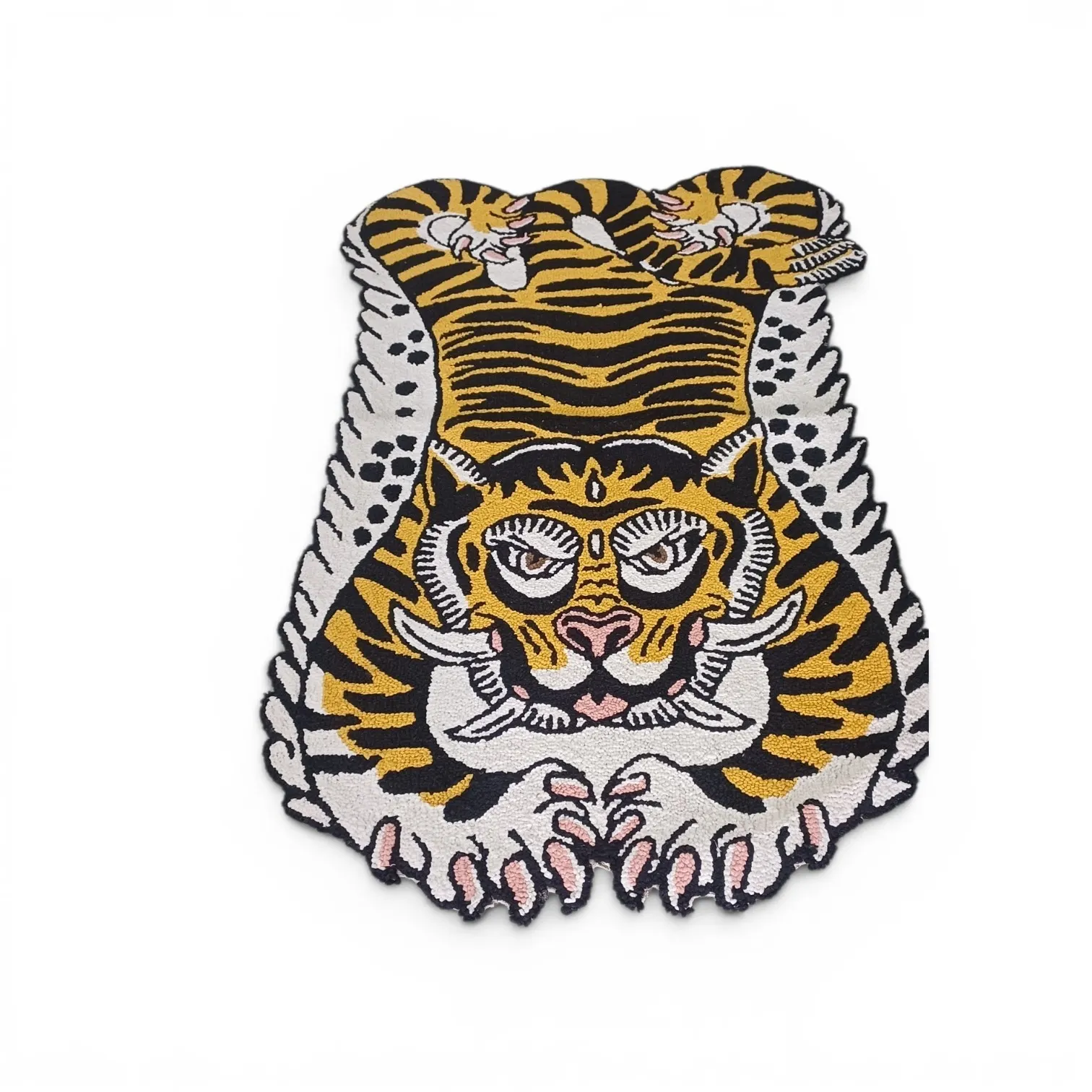 A tiger-skin style rug in yellow, black and white with a stylised tiger face, spotted sides and paws, on a white background