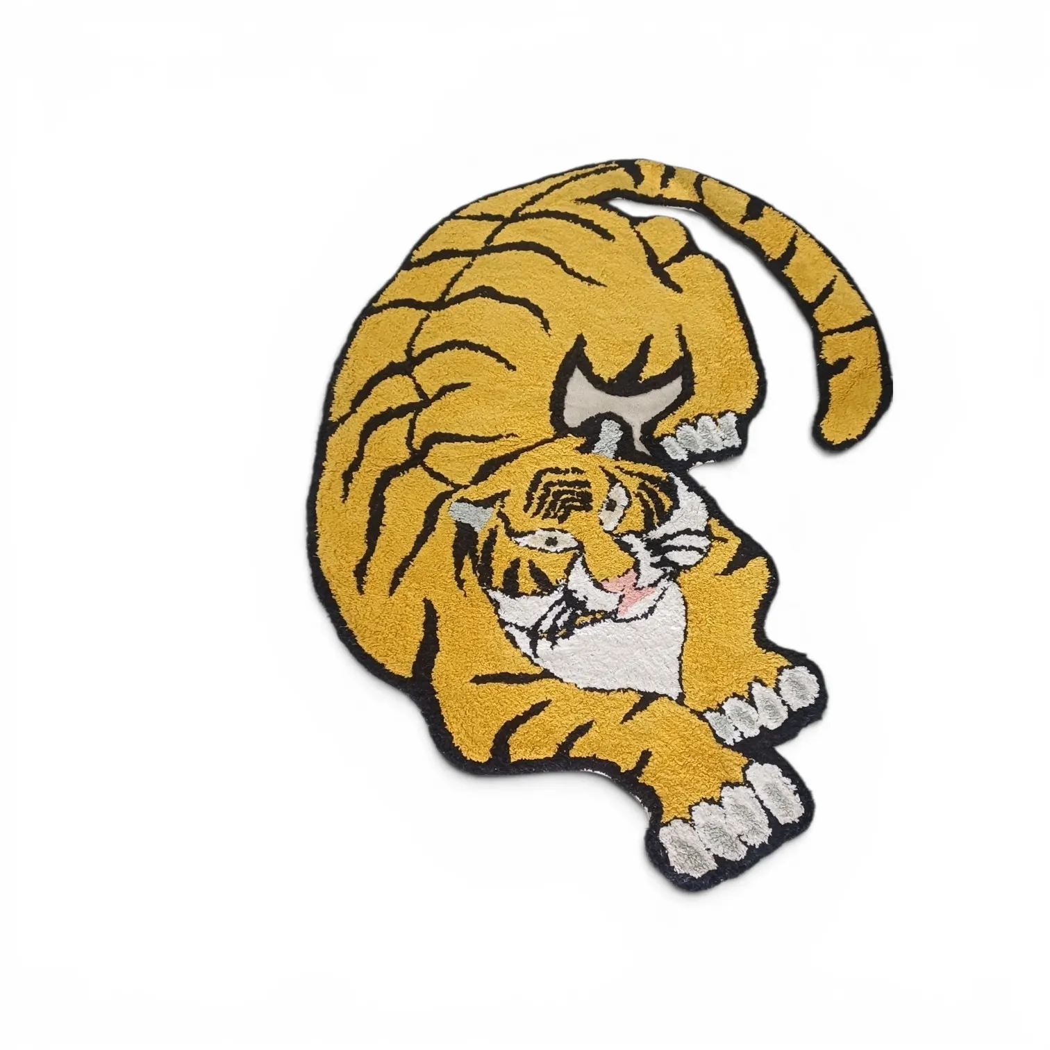 A crouching tiger rug in golden yellow with black stripes and a white chest, shaped to the animal outline, on a white background